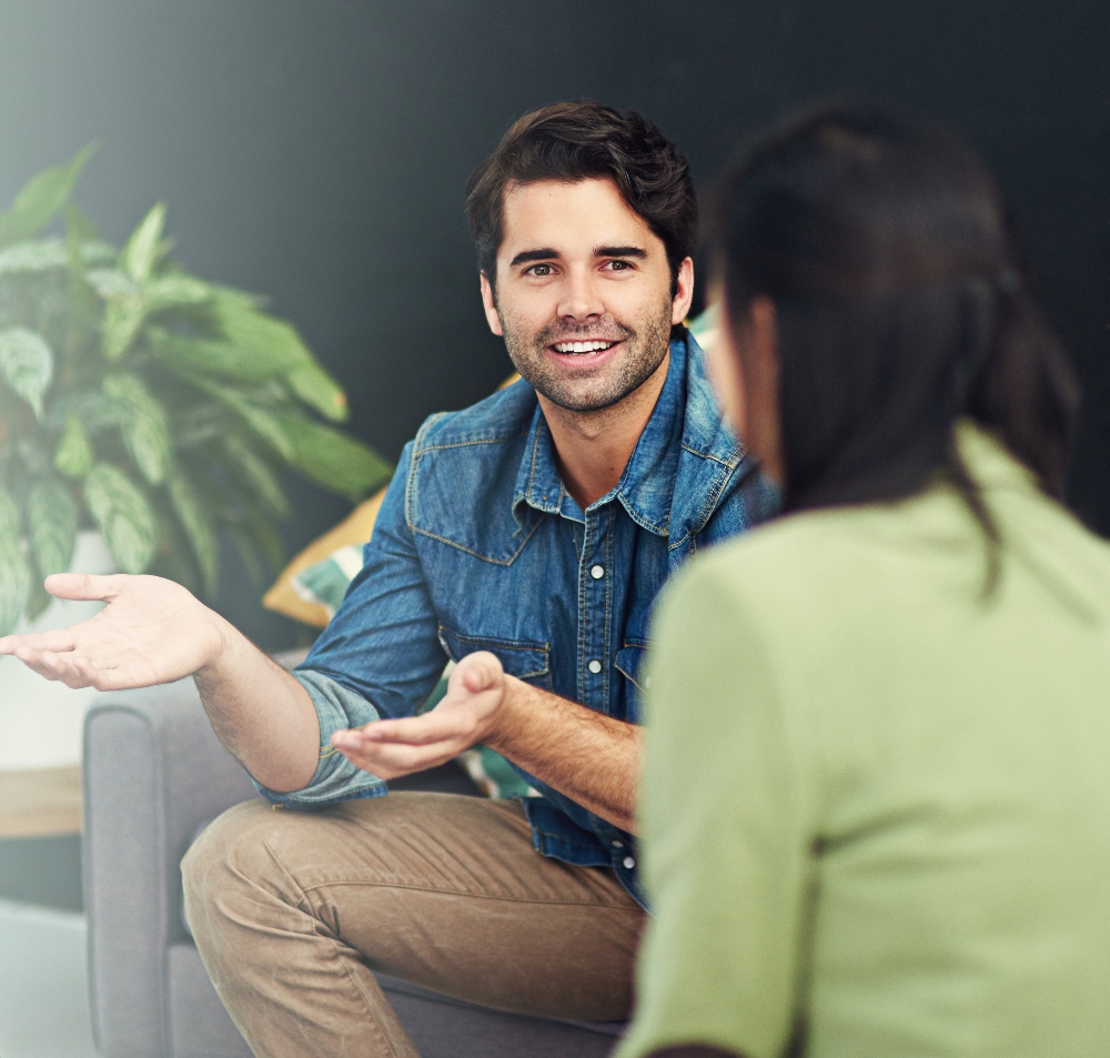 man talking to therapist on couch at outpatient treatment program for addiction