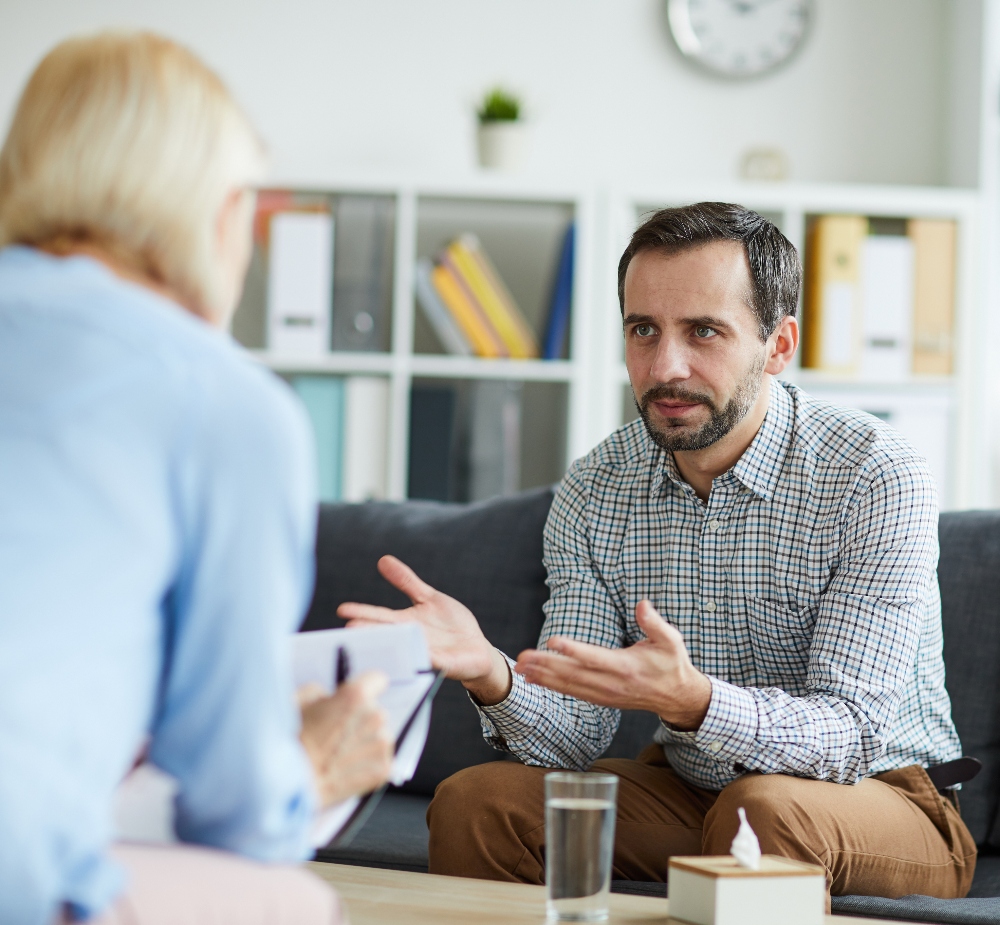 man speaking with therapist
